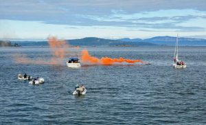 Pyroschein – Seenotsignal mit orangefarbener Rauchboje auf dem Meer als Beispiel für FKN und SKN